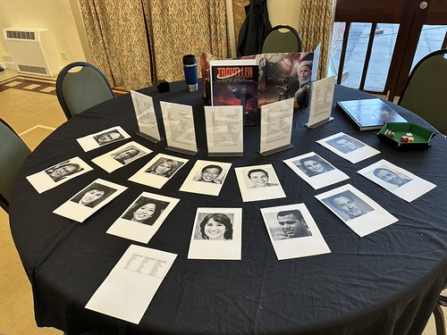 A photo of the table laid out ready to play with a fan of character sheets in standees and portraits for the characters to choose from, plus the screen and adventure showing.